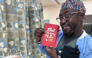 Male Nurse holding card