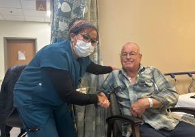 Happy patient shaking hands with nurse.