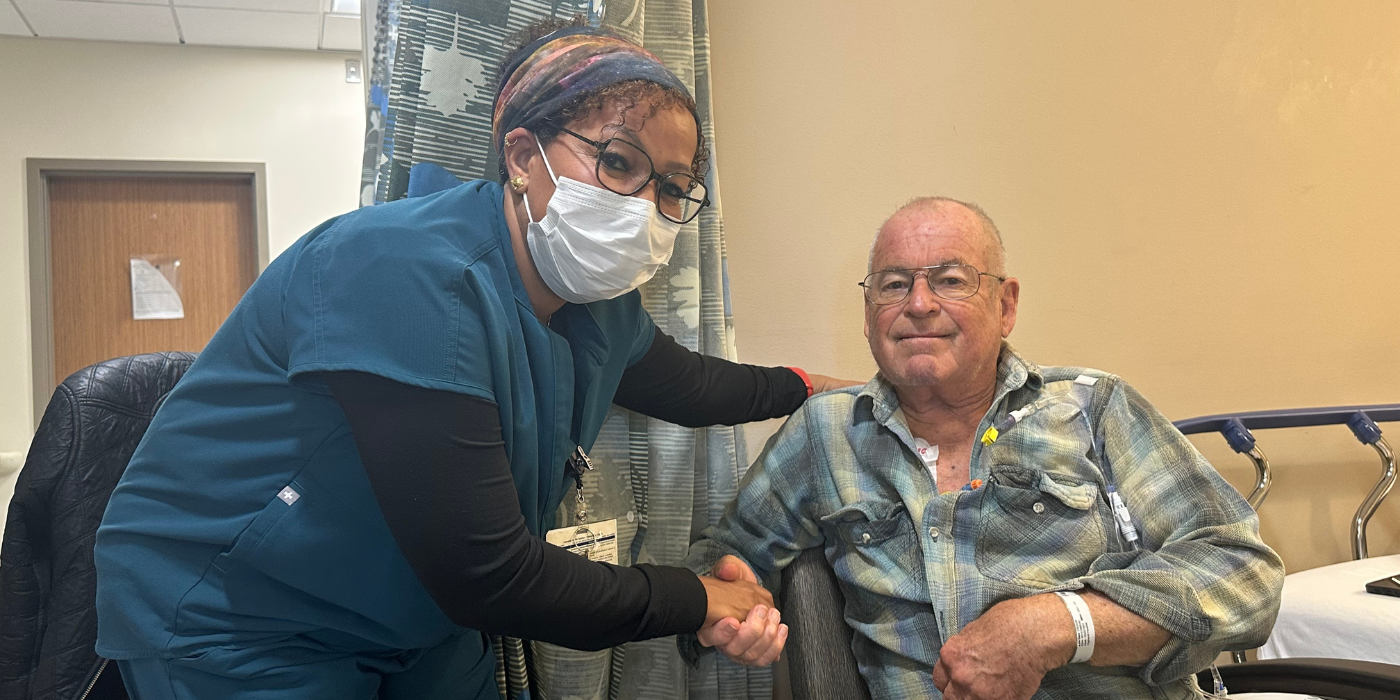 Happy patient shaking hands with nurse.